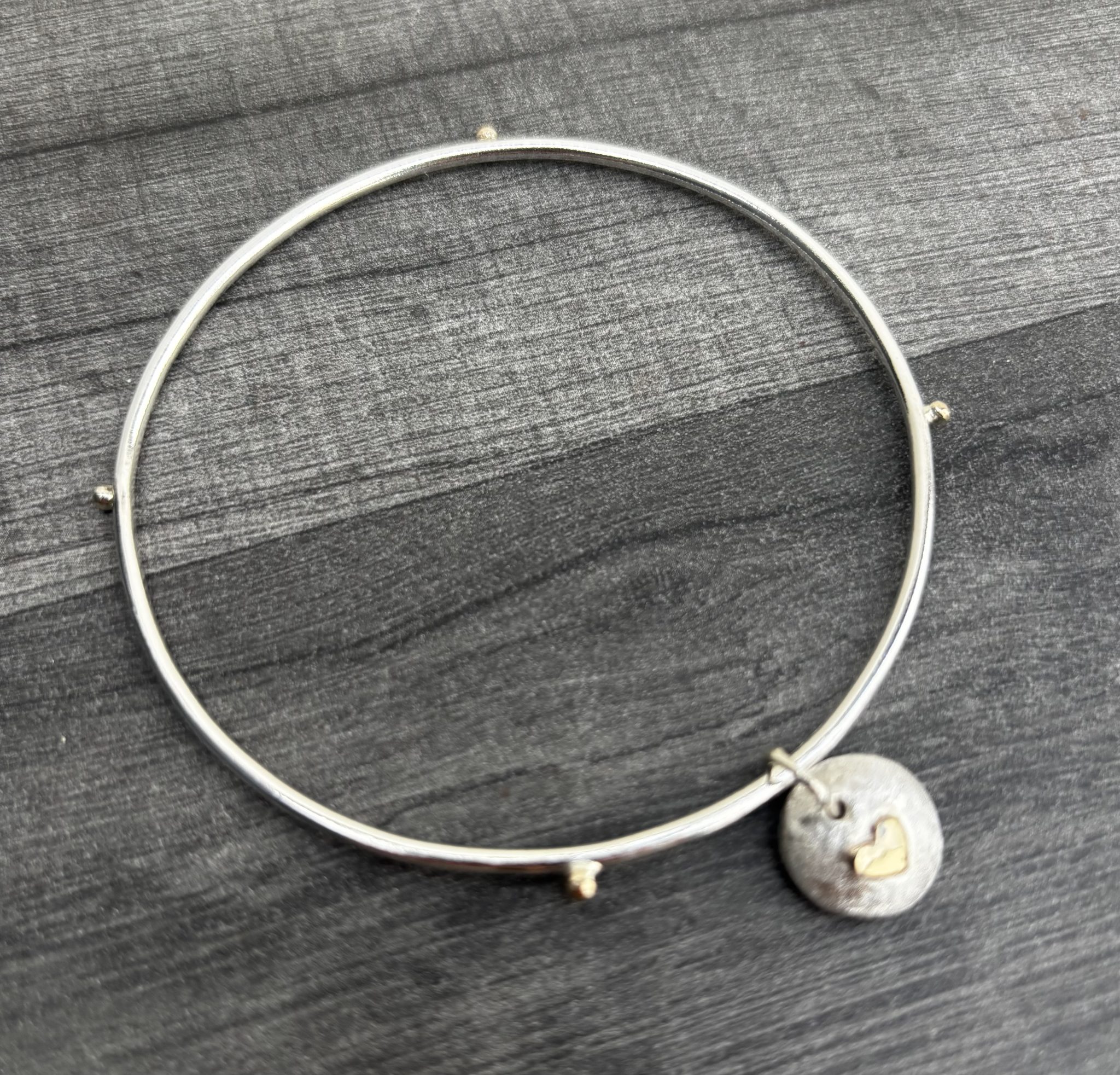 Pebble Charm Bangle. Oval silver bangle, gold heart bangle, silver and gold bangle, charm pebble bangle.
