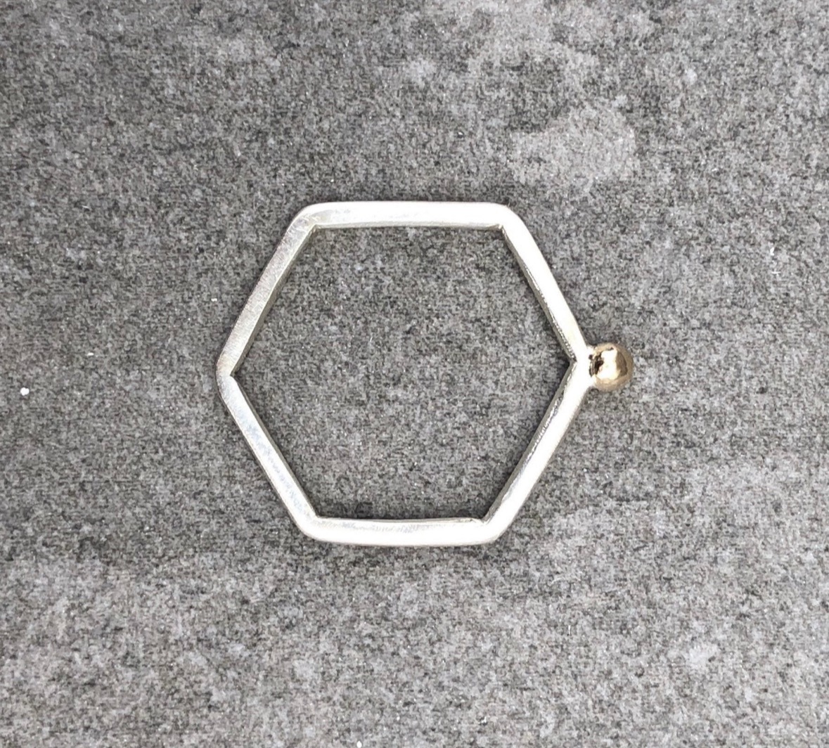 Silver hexagon ring with 9ct gold detail.